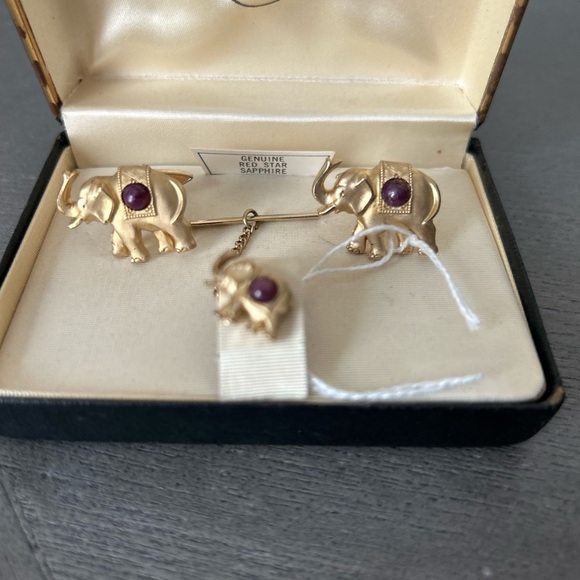 Levy’s Vintage gold and genuine red star sap elephant cuff links and tie tac.